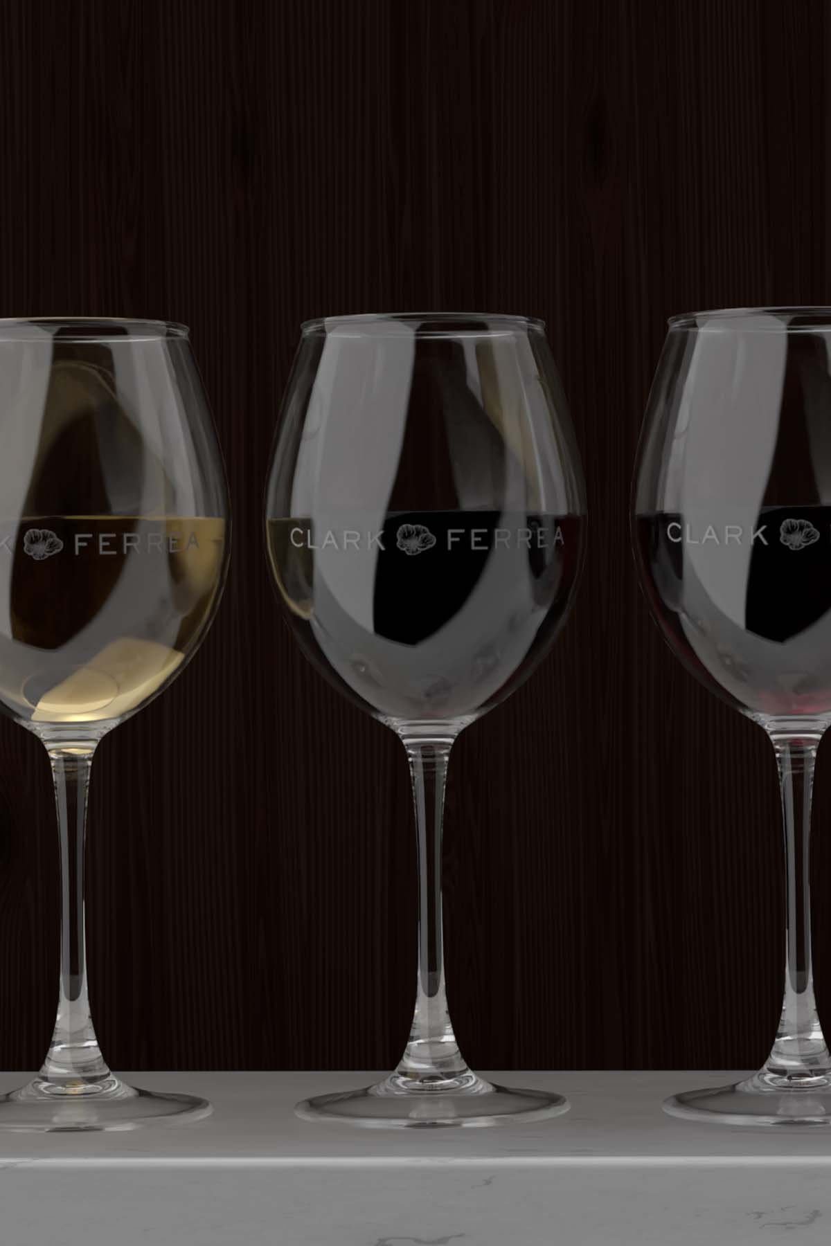 a close up photo of three Clark Ferrea wine glasses filled with wine