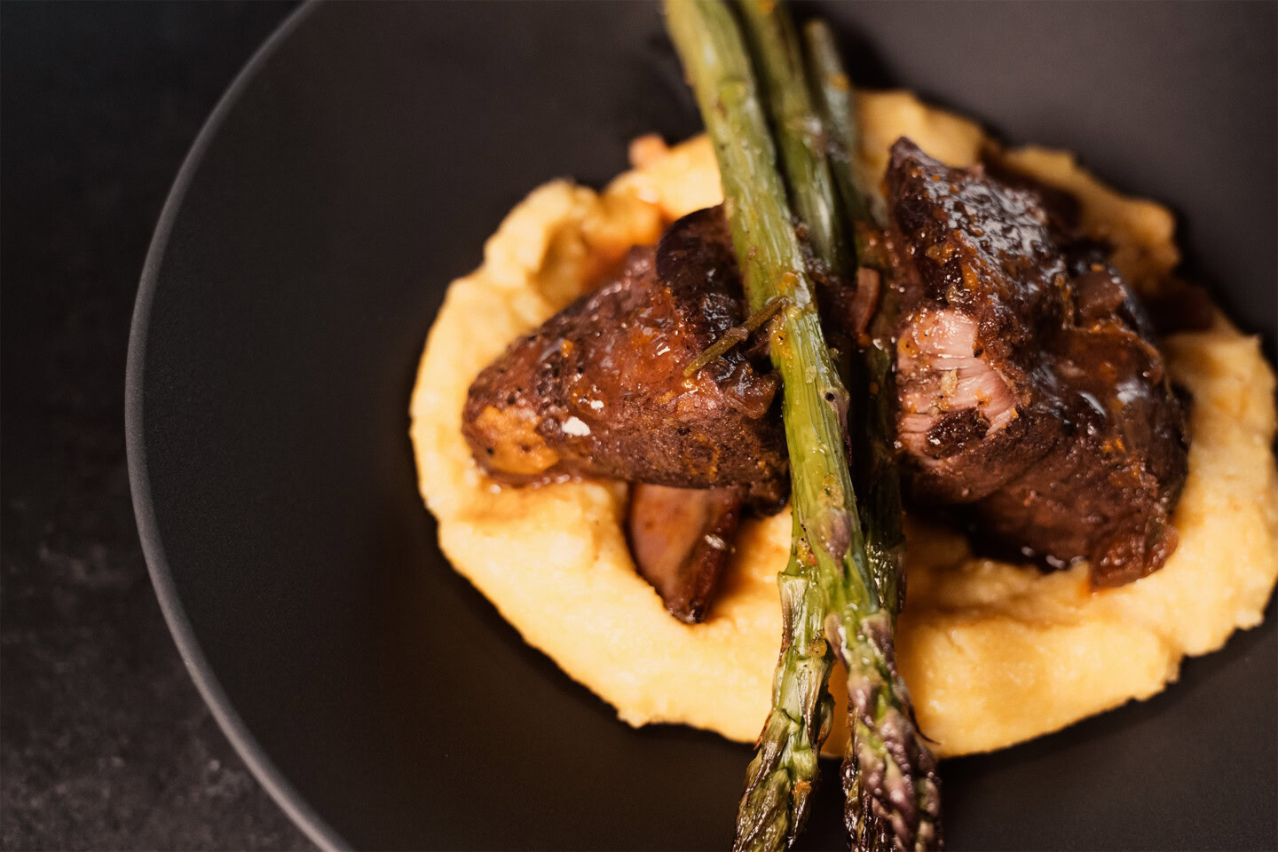 plated short rib plus polenta and asparagus